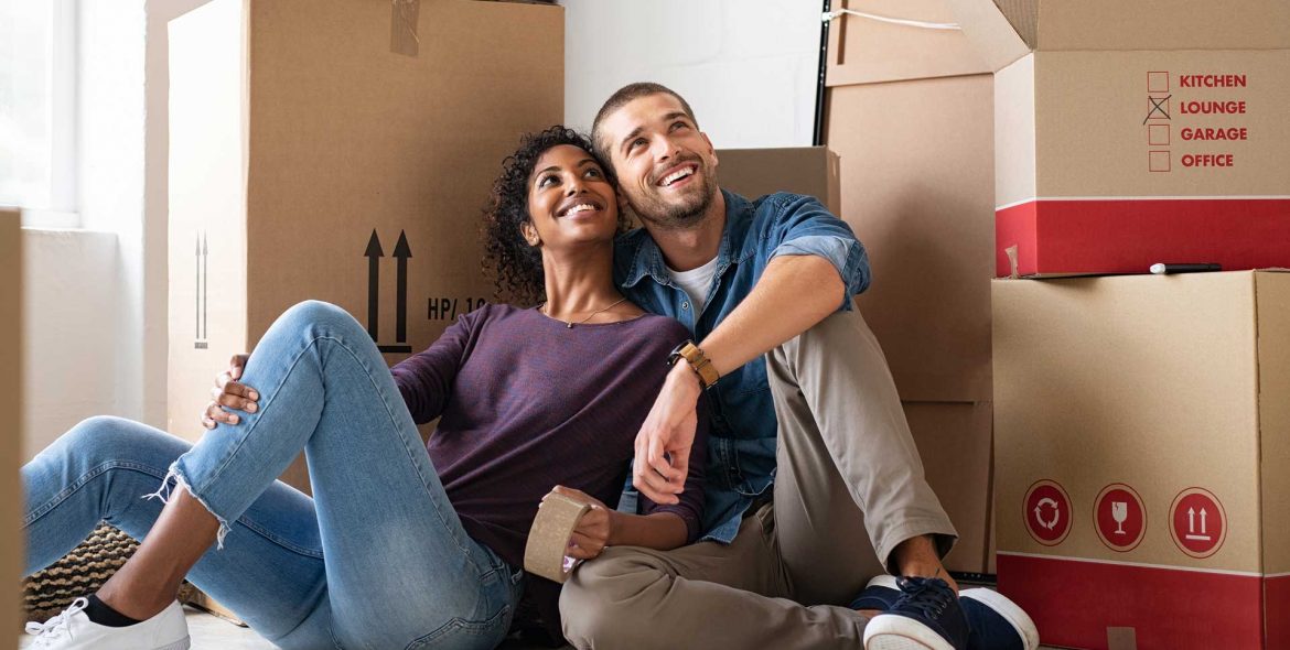 multiethnic-couple-in-new-home-with-boxes1920